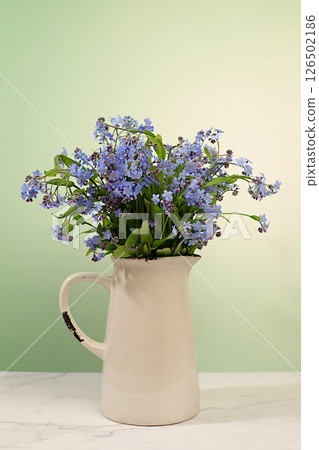 Abstract flower arrangement,Beautiful spring forget-me-not flowers in vase on light background,flyer. still life and template for design,floral holiday card and summer greeting concept, 126502186
