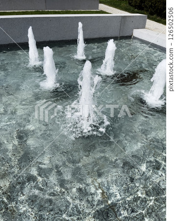 Fountain water texture background, falling streams of fresh fountain, splash pattern of waterfall, movement of waterfalls in summer park, fountain water texture background 126502506