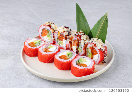 Vibrant Red Tobiko Salmon Avocado Cream Cheese Rolls with Almond Garnish Vibrant Red Tobiko Salmon Avocado Cream Cheese Rolls with Almond Garnish 126503160