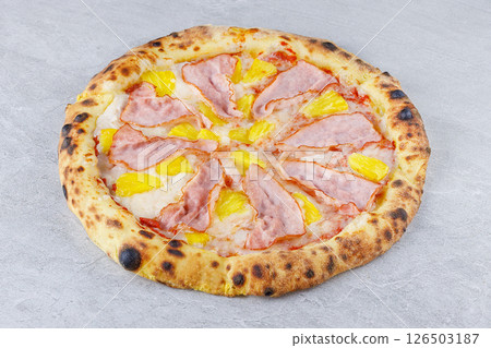 Hawaiian Pizza with Ham and Pineapple on Stone Surface 126503187