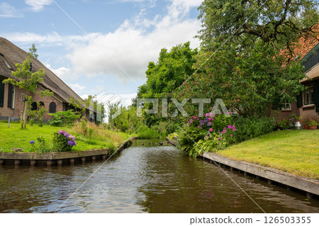 Landscape view of famous Giethoorn village in Netherlands with canals and traditional houses Landscape view of famous Giethoorn village in Netherlands with canals and traditional houses 126503355