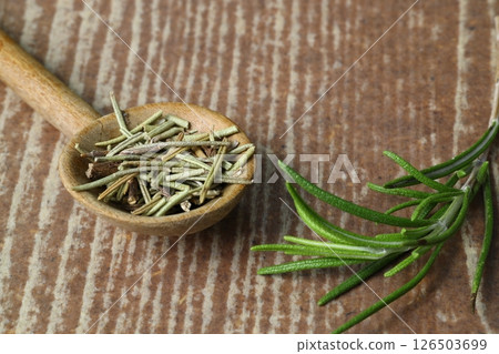 Dry organic background or texture of rosemary leaves. Healthy food concept . a wooden spoon with rosemary Dry organic background or texture of rosemary leaves. Healthy food concept . a wooden spoon with rosemary 126503699
