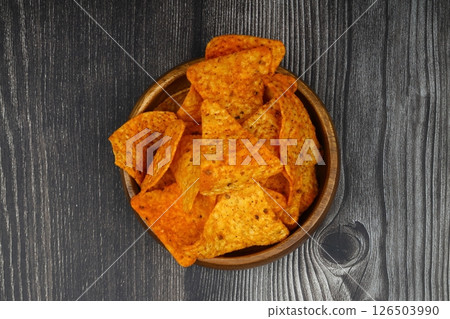 Nachos in a wooden bowl. Tortilla chips on wooden background. 126503990