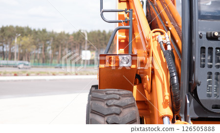 Heavy machinery is seen functioning amidst a war zone, with a focus on the details of the construction equipment and the surrounding area. 126505888