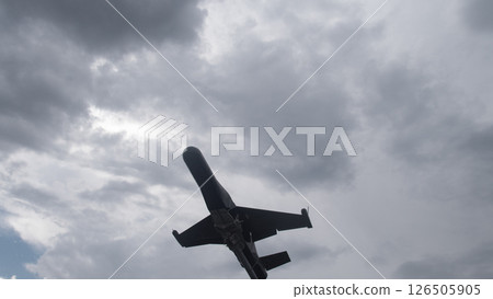 A military drone soars against dark clouds, emphasizing its role in warfare and surveillance during a crucial mission in a conflict zone. 126505905
