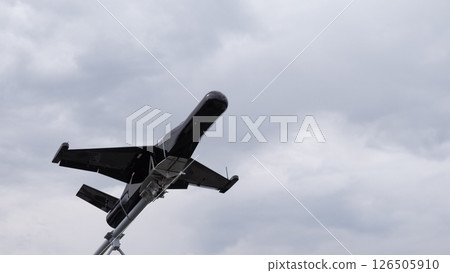 A military drone is poised for takeoff in a conflict area. Dark clouds loom above, highlighting the intensity of wartime operations and aerial surveillance. A military drone is poised for takeoff in a conflict area. Dark clouds loom above, highlighting the intensity of wartime operations and aerial surveillance. 126505910