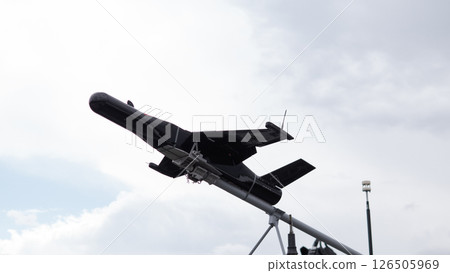 A drone takes off from a launch platform, ready for its mission in a war-torn area, showcasing advanced technology used in modern warfare. A drone takes off from a launch platform, ready for its mission in a war-torn area, showcasing advanced technology used in modern warfare. 126505969