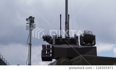 Military personnel skillfully operate advanced weaponry in a training setting, showcasing readiness and precision amid overcast conditions. Military personnel skillfully operate advanced weaponry in a training setting, showcasing readiness and precision amid overcast conditions. 126505971