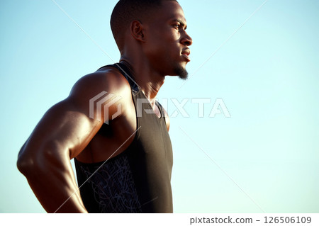 Focused Athlete Prepares for Competition on a Sunny Day at the Track 126506109