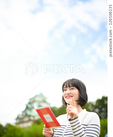 Tourist woman and guidebook 126506135