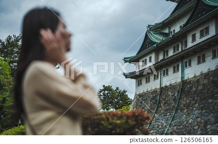 A castle and a woman in the foreground 126506165