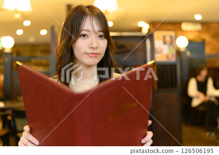 Woman holding a menu book 126506195
