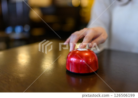 Woman's hand pressing the call bell Woman's hand pressing the call bell 126506199