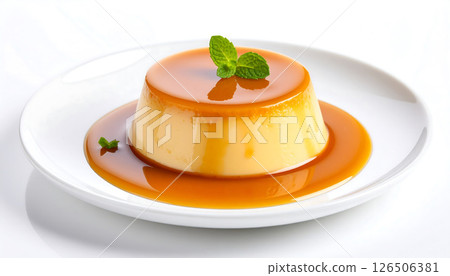 Close-up of a caramel flan or creme caramel on a white plate with mint garnish, simple and delicious dessert. 126506381