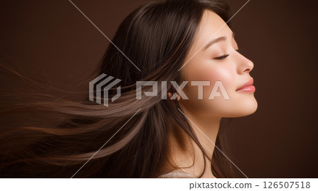 A woman with a beautiful profile and black hair fluttering in the wind 126507518