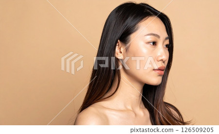Smooth, straight, long hair that stands out against a beige background 126509205