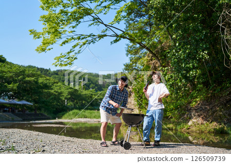 Two men having a barbecue Two men having a barbecue 126509739