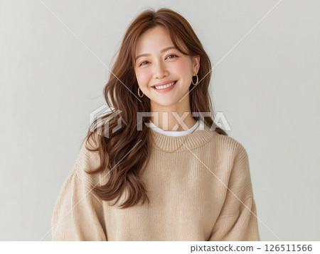 A middle-aged woman with a smile who looks good with long hair and knitwear 126511566