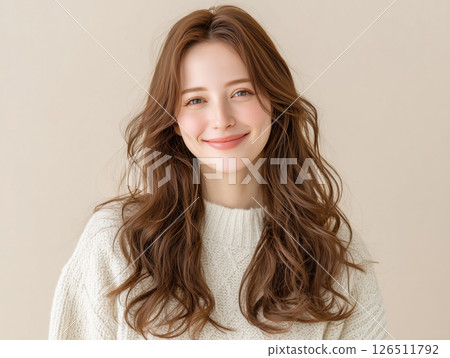 A middle-aged woman with a smile who looks good with long hair and knitwear 126511792