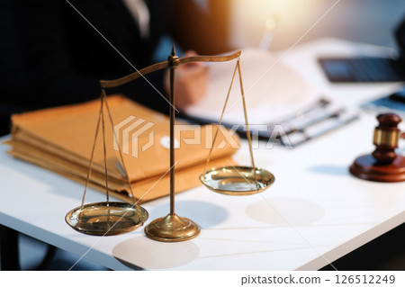 Judge gavel with Justice lawyers having team meeting at law firm background. Concepts of Law and Legal services. Judge gavel with Justice lawyers having team meeting at law firm background. Concepts of Law and Legal services. 126512249