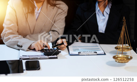 Judge gavel with Justice lawyers having team meeting at law firm background. Concepts of Law and Legal services. 126512258