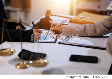 Judge gavel with Justice lawyers having team meeting at law firm background. Concepts of Law and Legal services. 126512259