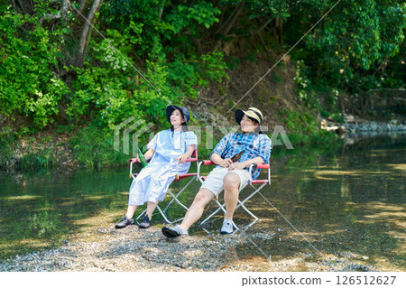 Men and women cooling off by the river 126512627