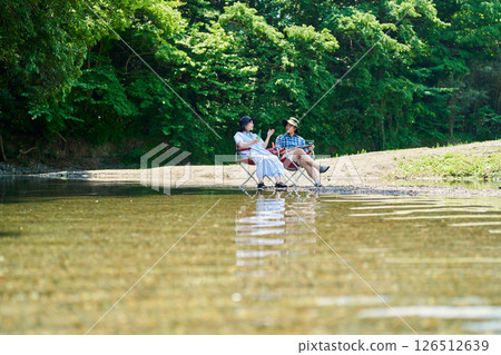 Men and women cooling off by the river 126512639