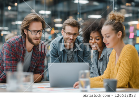 Business scene with diverse young male and female business team meeting to discuss project on laptop 126512858