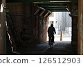 Silhouette of a bicycle running under an overpass 126512903