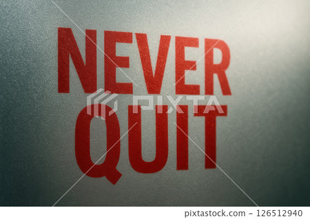 Never Quit in Bold Red on Frosted Glass, Minimalist Close-up 126512940
