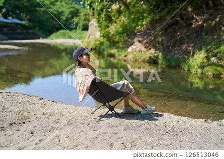 A woman relaxing on the river side 126513046