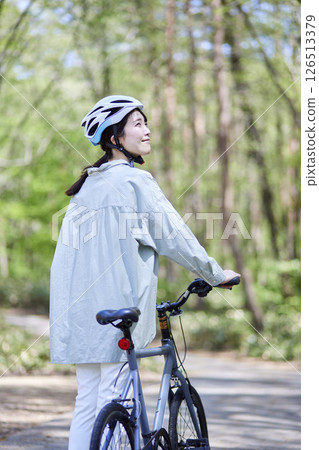 Japanese woman enjoying cycling in nature Japanese woman enjoying cycling in nature 126513379