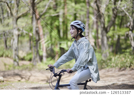 Japanese woman enjoying cycling in nature 126513387