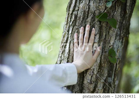 Japanese woman enjoying forest bathing in nature Japanese woman enjoying forest bathing in nature 126513431