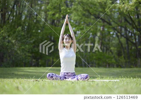 Japanese woman enjoying yoga in nature Japanese woman enjoying yoga in nature 126513469