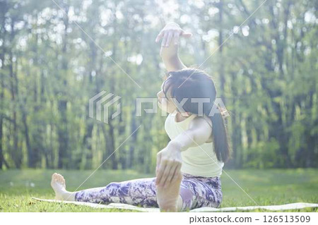 Japanese woman enjoying yoga in nature Japanese woman enjoying yoga in nature 126513509