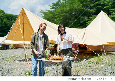 Men and women enjoying barbecue Men and women enjoying barbecue 126514007