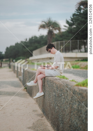 A man in his 20s working remotely at a resort 126514506
