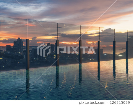 Stunning sunset view over a city skyline from a rooftop pool during twilight hours 126515039