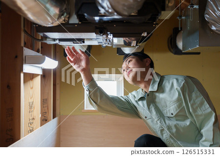 Male worker inspecting air conditioning 126515331