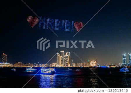 Drone show in night sky over Bluewaters and JBR Beach. High quality photo Drone show in night sky over Bluewaters and JBR Beach. High quality photo 126515443