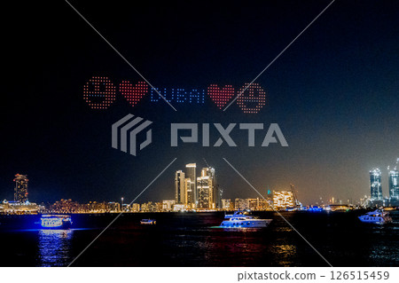 Drone show in night sky over Bluewaters and JBR Beach. High quality photo 126515459