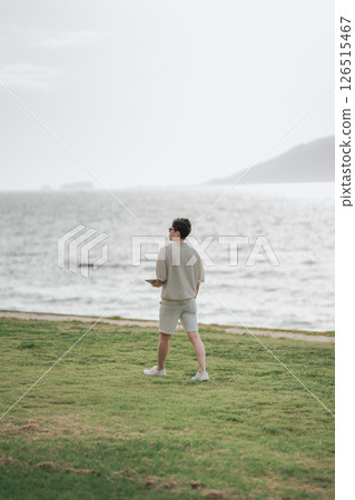 A man in his 30s working remotely at a resort A man in his 30s working remotely at a resort 126515467