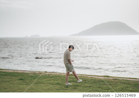 A man in his 30s working remotely at a resort A man in his 30s working remotely at a resort 126515469
