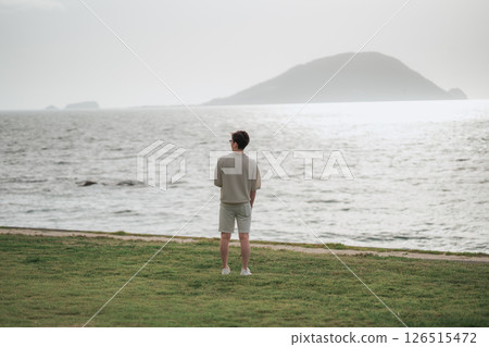 A man in his 30s working remotely at a resort A man in his 30s working remotely at a resort 126515472