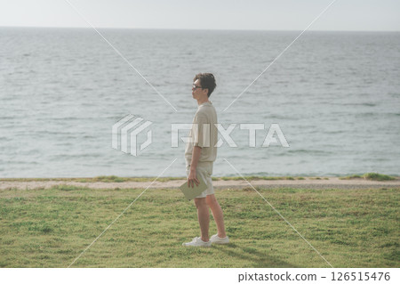 A man in his 30s working remotely at a resort 126515476