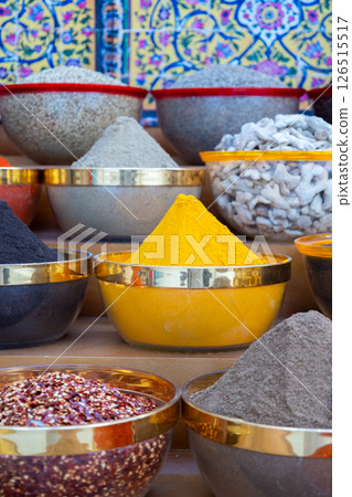 Traditional spices market. Pots and wooden tubs stand in row with colorful tea, spices, fruits, roots, flowers. Street bazaar. Dubai, UAE. Vertical photo Traditional spices market. Pots and wooden tubs stand in row with colorful tea, spices, fruits, roots, flowers. Street bazaar. Dubai, UAE. Vertical photo 126515517