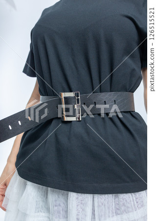 Close-up of black leather belt on model. High fashion. Vertical photo. High quality photo Close-up of black leather belt on model. High fashion. Vertical photo. High quality photo 126515521