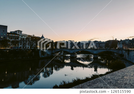 Rome in the evening. Panoramic view of Castel Sant'Angelo and Bridge in Rome with reflection in Tiber river. Rome in the evening. Panoramic view of Castel Sant'Angelo and Bridge in Rome with reflection in Tiber river. 126515590